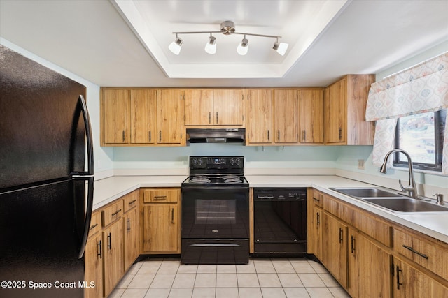 kitchen featuring under cabinet range hood, light countertops, black appliances, a raised ceiling, and a sink