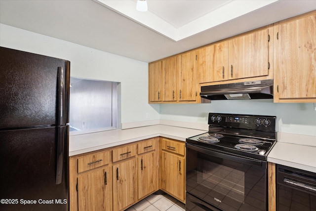 kitchen with under cabinet range hood, black appliances, light tile patterned floors, and light countertops