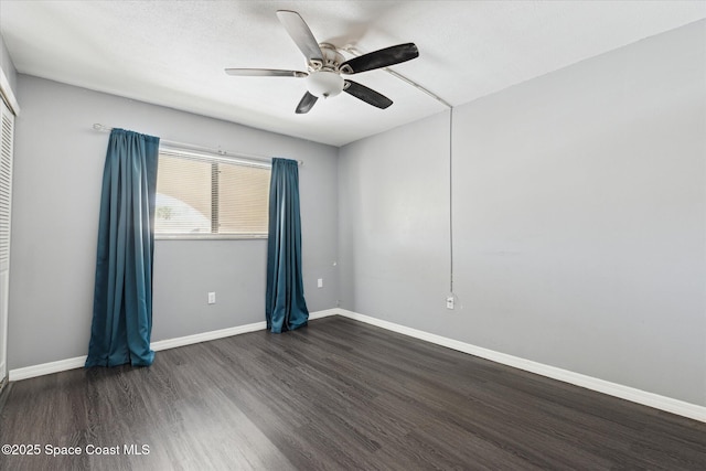 unfurnished room with a ceiling fan, dark wood-style floors, baseboards, and a textured ceiling