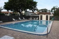 view of swimming pool with a patio and fence