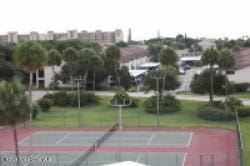 view of sport court with a lawn