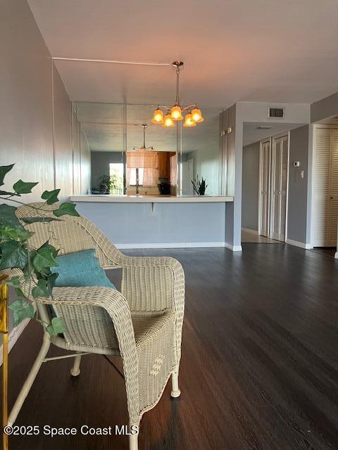 interior space with wood finished floors, visible vents, and baseboards