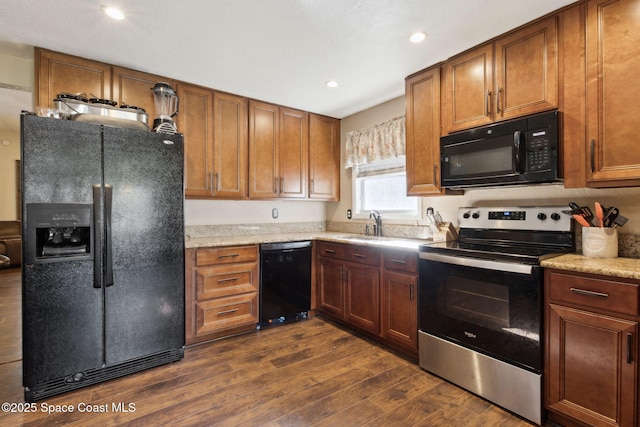 kitchen with black appliances, dark wood-style floors, and brown cabinets