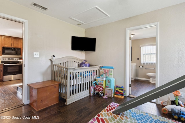 bedroom featuring baseboards, attic access, visible vents, and dark wood-style flooring