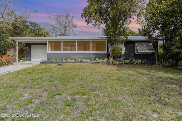 single story home with a yard and a carport