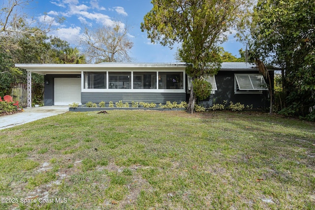 ranch-style house with a front yard, a carport, and a sunroom