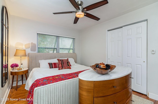 bedroom with a closet, ceiling fan, and light hardwood / wood-style flooring