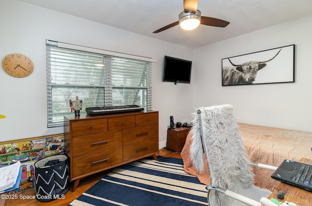 bedroom featuring multiple windows, dark wood-type flooring, and ceiling fan