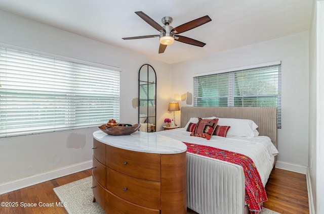 bedroom with ceiling fan and dark hardwood / wood-style flooring