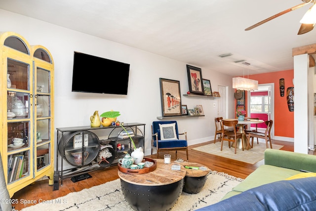 living room with ceiling fan and wood-type flooring