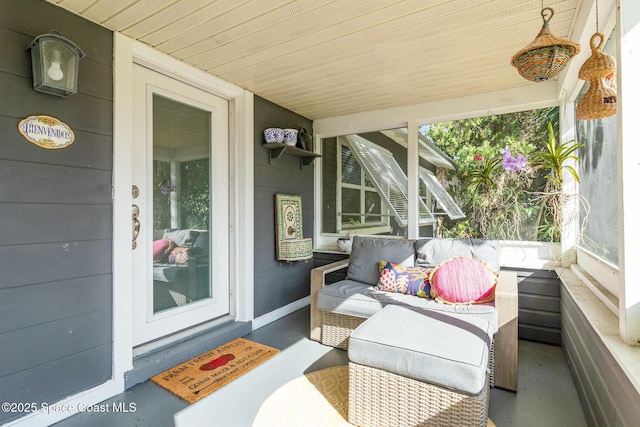 sunroom / solarium featuring wood ceiling