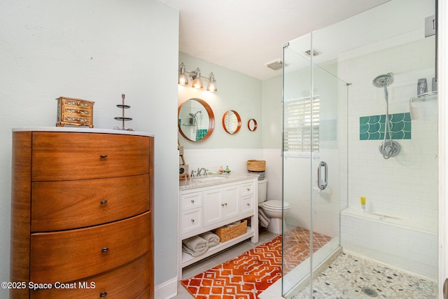 bathroom featuring walk in shower, toilet, tile walls, vanity, and tile patterned flooring