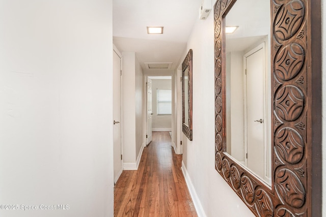 hallway with hardwood / wood-style flooring