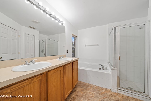 bathroom featuring vanity and shower with separate bathtub