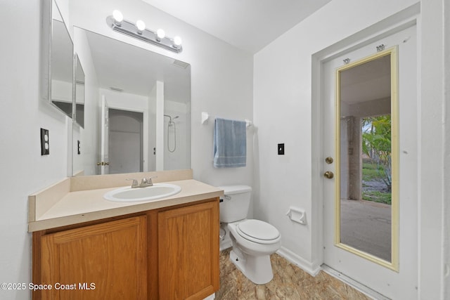 bathroom with vanity, toilet, and walk in shower