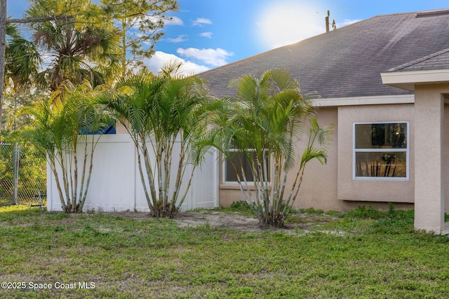 view of side of property with a yard