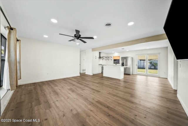 unfurnished living room featuring ceiling fan and light wood-type flooring