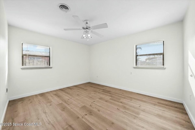 spare room with ceiling fan and light wood-type flooring