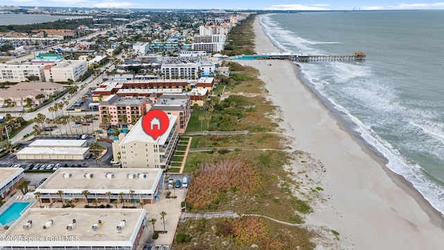 drone / aerial view with a beach view and a water view