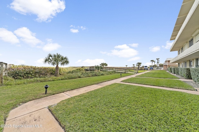 view of property's community featuring a lawn