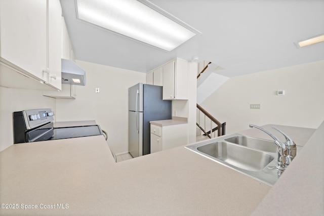 kitchen featuring sink, appliances with stainless steel finishes, white cabinetry, kitchen peninsula, and wall chimney exhaust hood