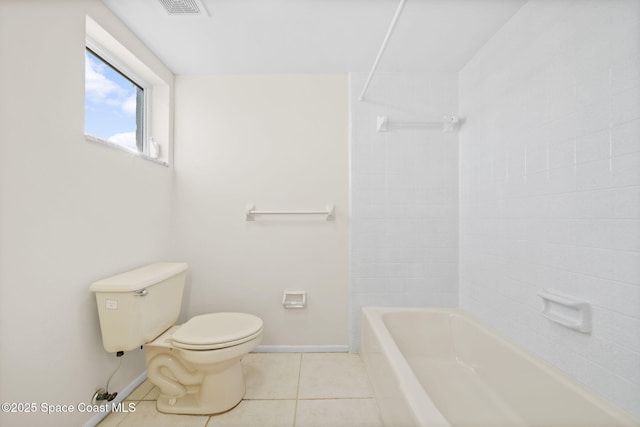 bathroom featuring tile patterned flooring, shower / tub combination, and toilet