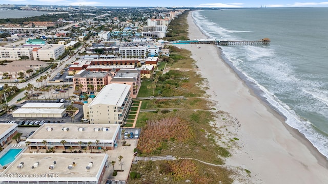 drone / aerial view featuring a view of the beach and a water view