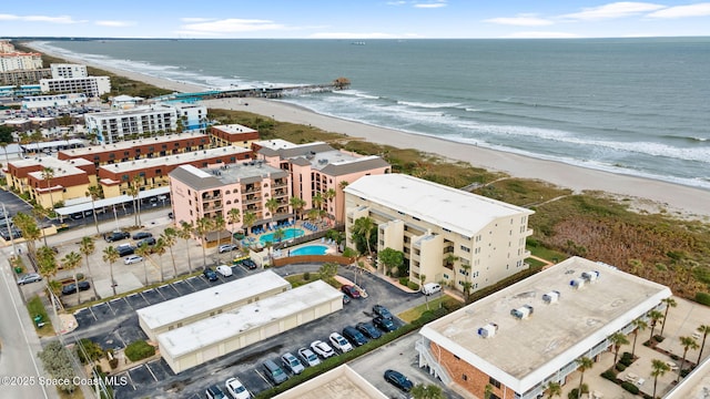 bird's eye view featuring a water view and a beach view