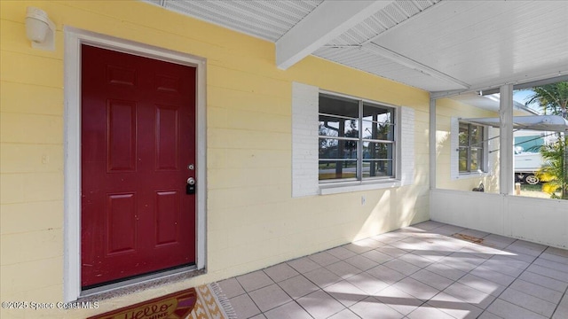 view of exterior entry with covered porch