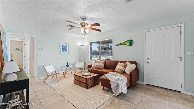 tiled living room featuring ceiling fan and a textured ceiling