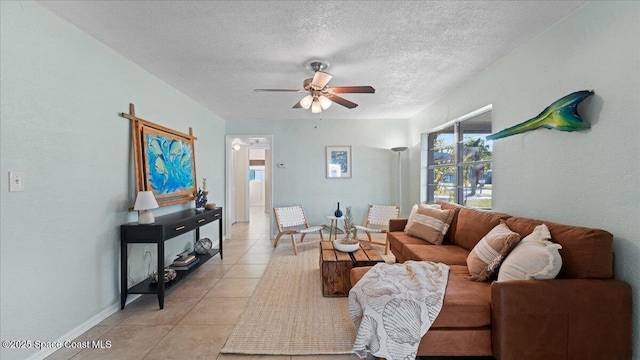 tiled living room with a textured ceiling and ceiling fan