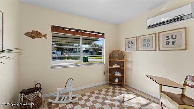 living area with an AC wall unit and light tile patterned flooring