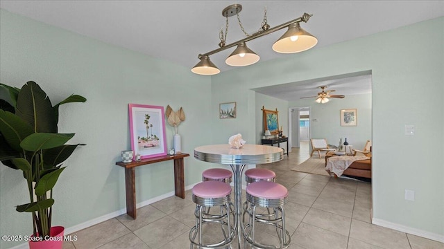 dining area with ceiling fan and light tile patterned flooring