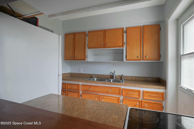 kitchen with sink, range with electric stovetop, and white refrigerator