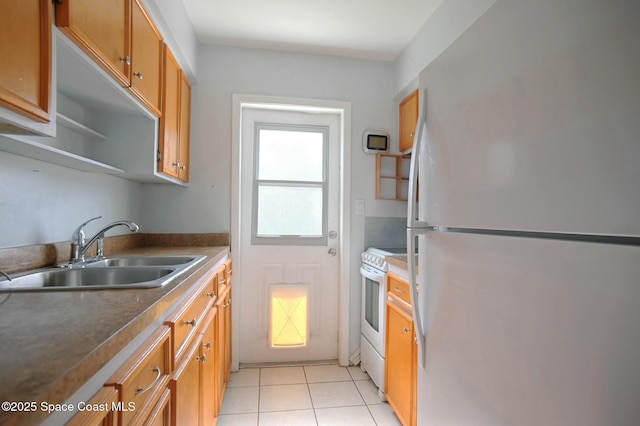 kitchen featuring white appliances, sink, and light tile patterned floors