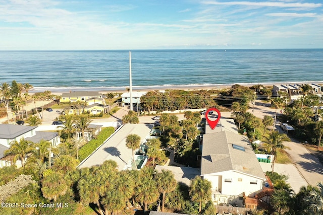 bird's eye view with a water view and a beach view