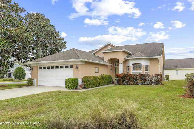 view of front of house featuring a garage and a front lawn