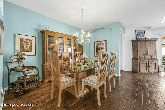 dining area featuring an inviting chandelier and dark hardwood / wood-style floors