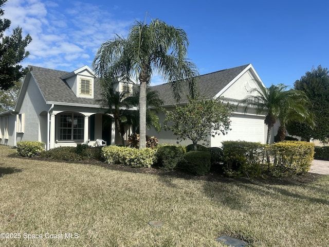 view of front of home featuring a garage and a front lawn