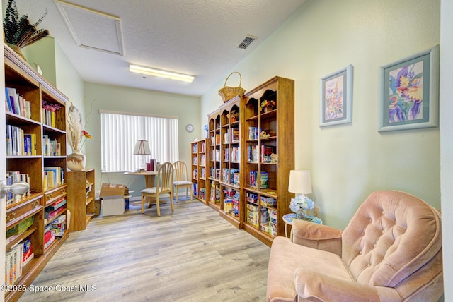 office space featuring a textured ceiling and light hardwood / wood-style floors