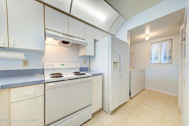 kitchen with white appliances, washer and clothes dryer, a textured ceiling, and white cabinets