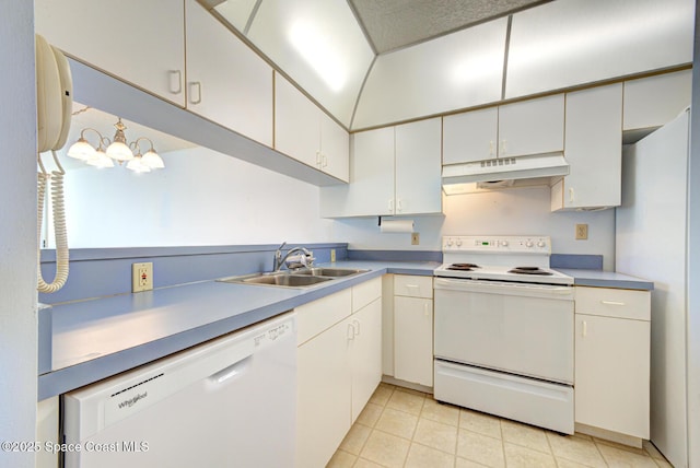 kitchen with white appliances, light tile patterned floors, sink, and white cabinets