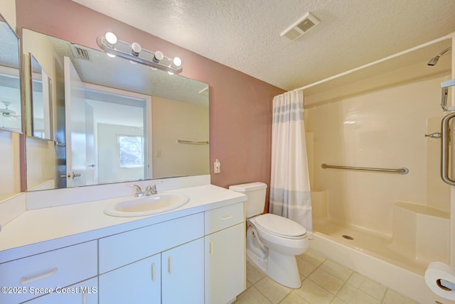 bathroom with tile patterned flooring, vanity, a textured ceiling, a shower with curtain, and toilet