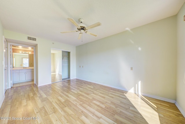 unfurnished bedroom with ceiling fan, light hardwood / wood-style floors, and a closet