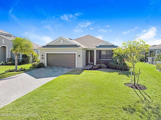 view of front of property with a garage and a front lawn