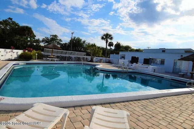 view of swimming pool featuring a patio area