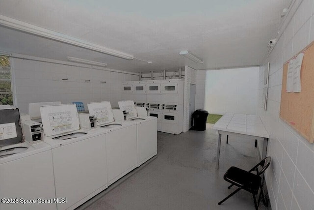 clothes washing area with independent washer and dryer