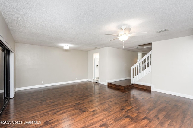 interior space with ceiling fan, a textured ceiling, and dark hardwood / wood-style flooring