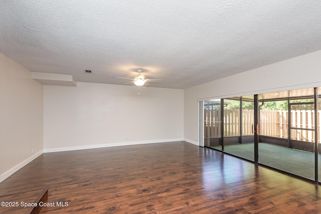 unfurnished room with ceiling fan, dark hardwood / wood-style floors, and a textured ceiling