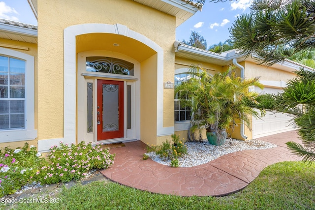 doorway to property featuring a garage